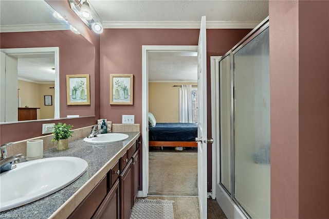 full bathroom featuring a textured ceiling, crown molding, and a sink