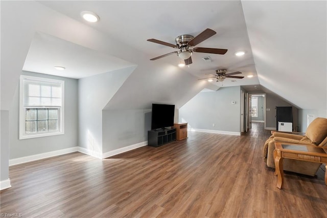 interior space with visible vents, lofted ceiling, baseboards, and wood finished floors