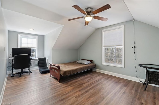 bedroom featuring lofted ceiling, wood finished floors, baseboards, and ceiling fan