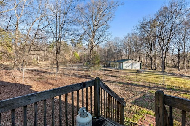 view of yard featuring a garage, an outdoor structure, and fence