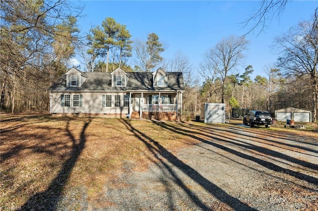 cape cod home featuring crawl space, a front lawn, covered porch, and driveway