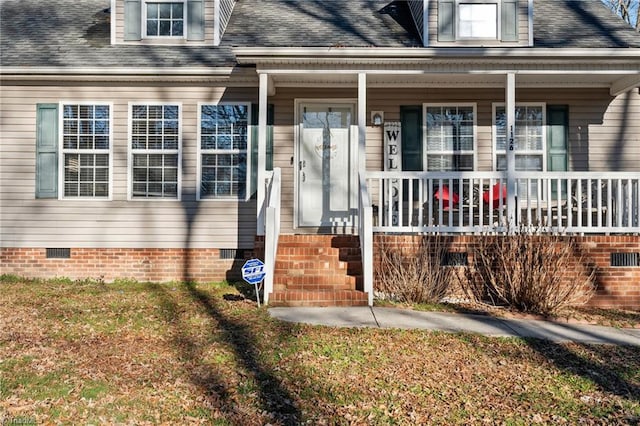 property entrance featuring a shingled roof, covered porch, and crawl space