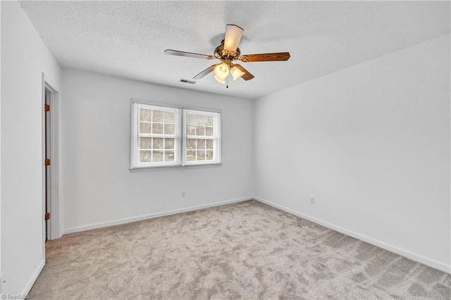 unfurnished room featuring a ceiling fan, a textured ceiling, visible vents, and carpet flooring