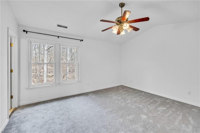 spare room featuring baseboards, visible vents, lofted ceiling, ceiling fan, and carpet flooring