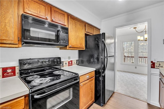 kitchen featuring ornamental molding, brown cabinets, an inviting chandelier, light countertops, and black appliances