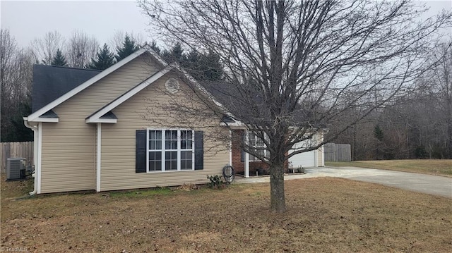 view of property exterior with a lawn and central air condition unit