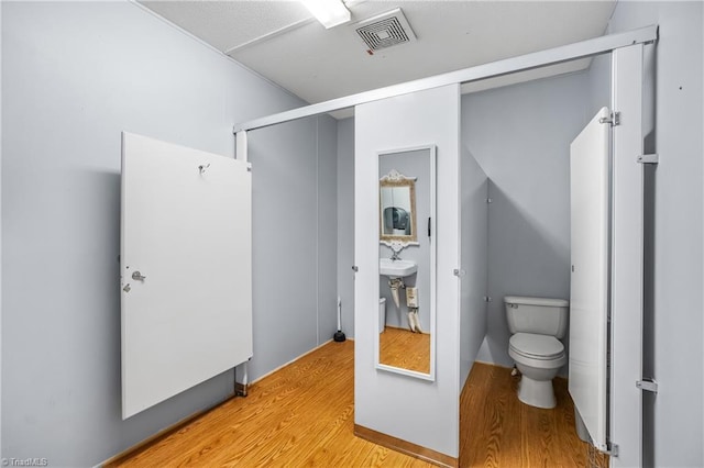 1255 Mountain View Rd, King, NC 27021 - bathroom with a sink, visible vents, toilet, and wood finished floors
