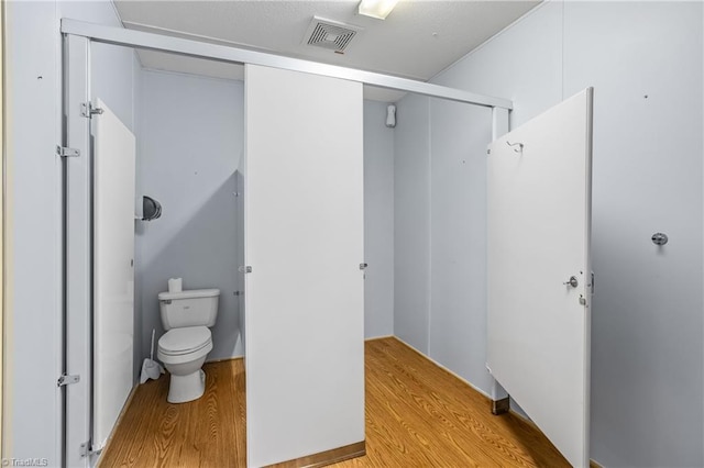 1255 Mountain View Rd, King, NC 27021 - bathroom featuring visible vents, toilet, and wood finished floors