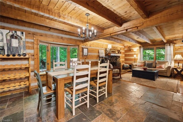 tiled dining room featuring wood ceiling, beamed ceiling, an inviting chandelier, and a wealth of natural light