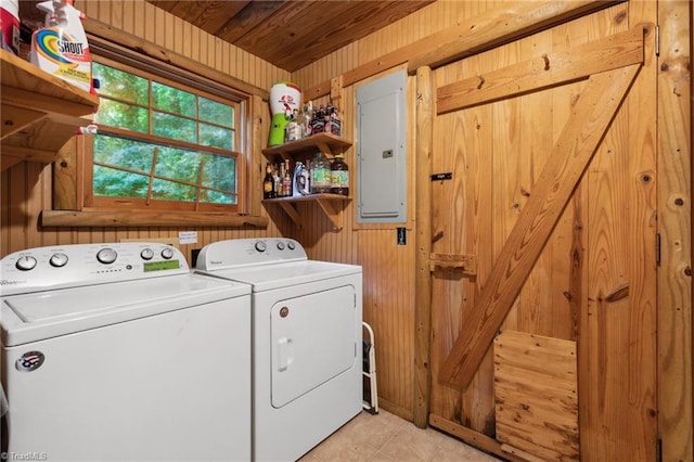 washroom with light tile patterned floors, wood walls, electric panel, washing machine and dryer, and wooden ceiling