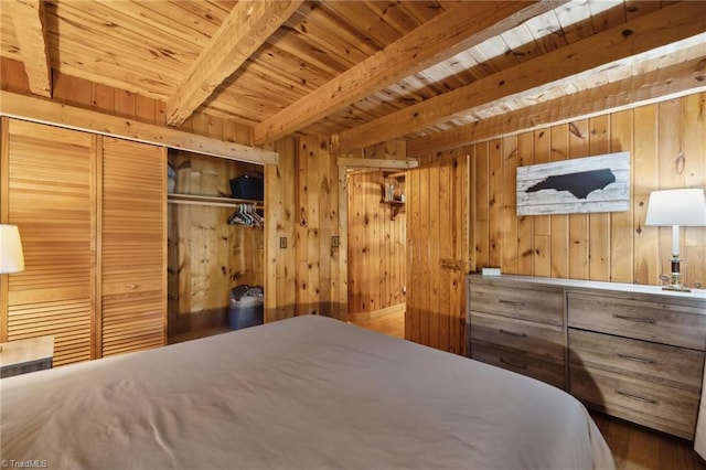 bedroom with beamed ceiling, wooden walls, and wooden ceiling