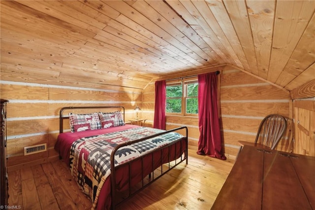 bedroom featuring vaulted ceiling, wooden ceiling, and hardwood / wood-style floors