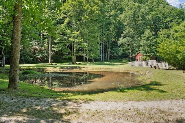 view of community with a water view and a yard