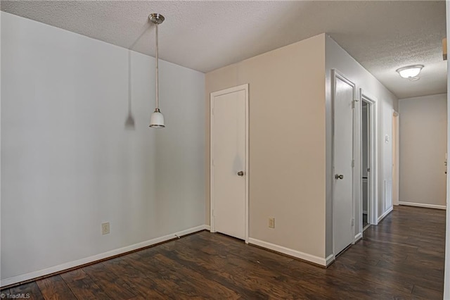 interior space featuring a textured ceiling and dark hardwood / wood-style flooring