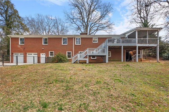 rear view of house with a garage, a sunroom, stairs, and brick siding