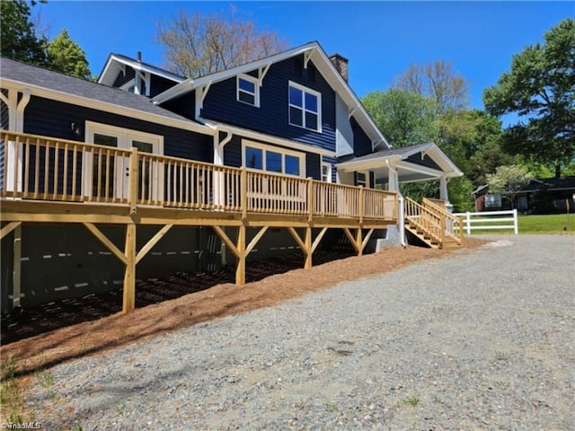 back of property featuring a deck