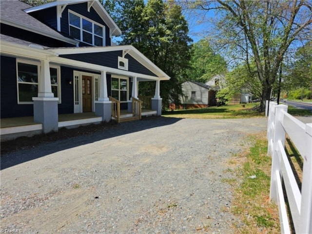 view of property exterior with covered porch