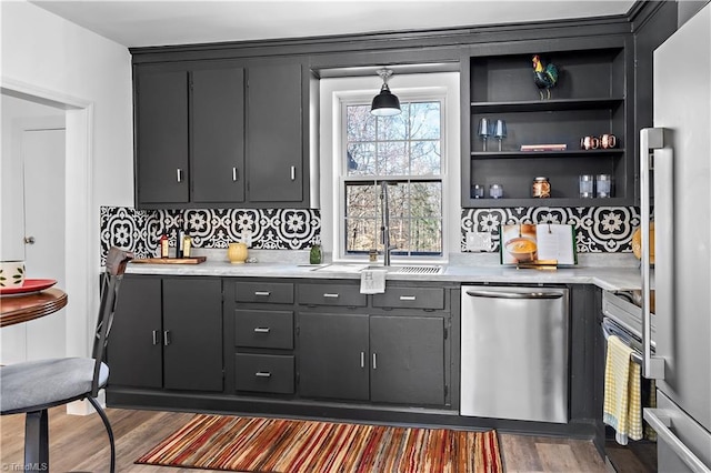 kitchen with dark wood finished floors, light countertops, open shelves, and stainless steel appliances