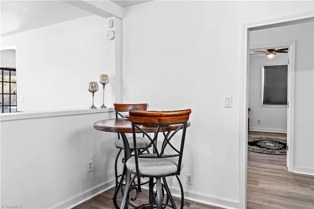 dining area featuring wood finished floors and baseboards