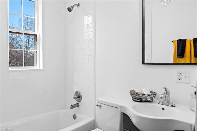 full bath featuring toilet, shower / bath combination, and a sink