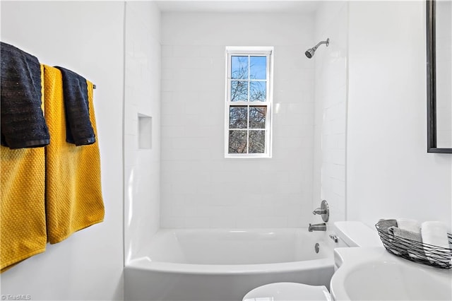 full bathroom featuring toilet, shower / bathing tub combination, and a sink