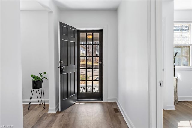 entryway with visible vents, wood finished floors, and baseboards