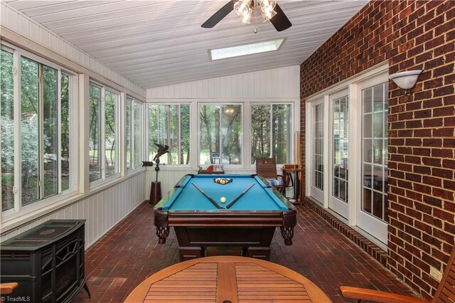 recreation room featuring vaulted ceiling, brick wall, ceiling fan, and pool table