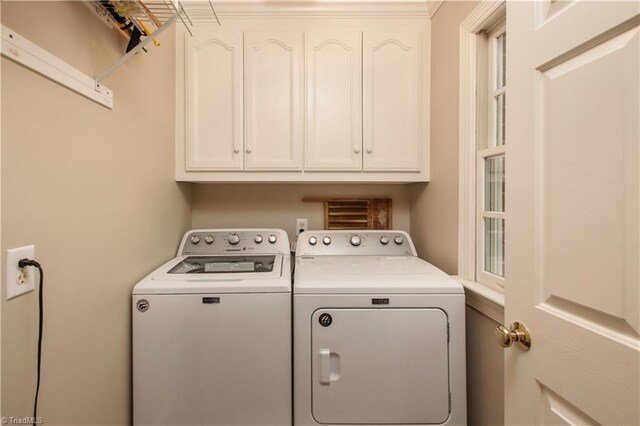 laundry area featuring cabinets and separate washer and dryer