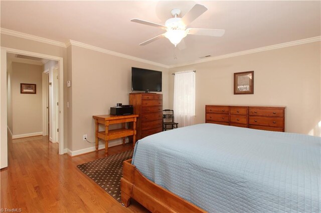 bedroom with light wood-type flooring, ceiling fan, and ornamental molding