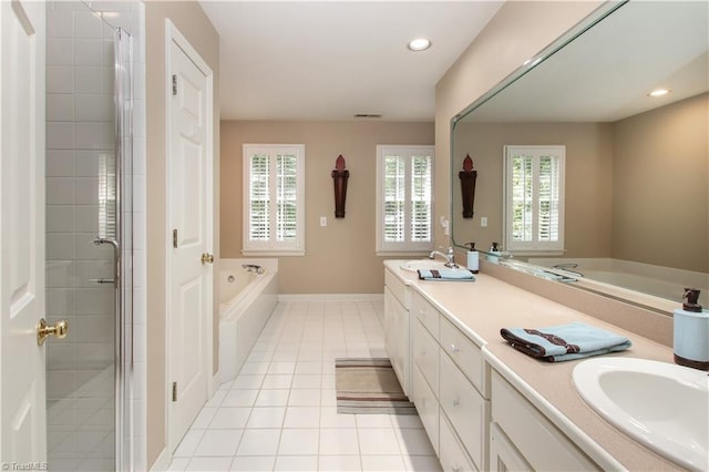 bathroom featuring a garden tub, a sink, a shower stall, tile patterned floors, and double vanity