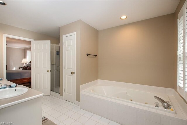 bathroom featuring vanity, shower with separate bathtub, and tile patterned floors