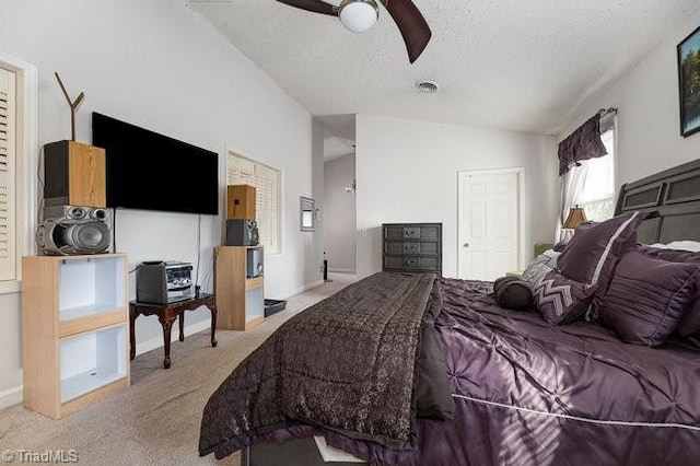 carpeted bedroom with ceiling fan, vaulted ceiling, and a textured ceiling