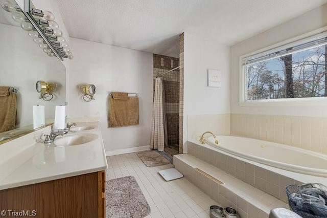 bathroom with vanity, shower with separate bathtub, tile patterned flooring, and a textured ceiling