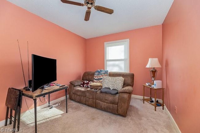 carpeted living room with ceiling fan