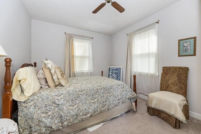 bedroom featuring light carpet and ceiling fan