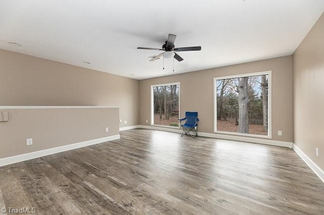 empty room featuring hardwood / wood-style flooring and ceiling fan