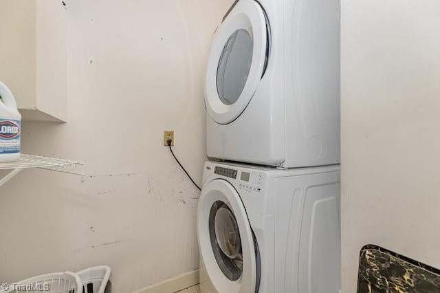 laundry area featuring stacked washing maching and dryer