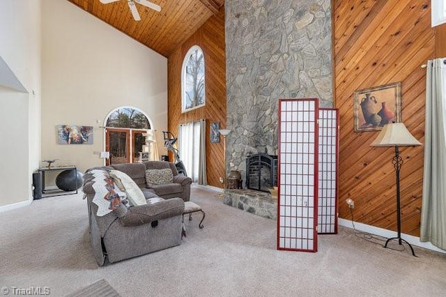 living room with carpet flooring, wood ceiling, a fireplace, and wood walls