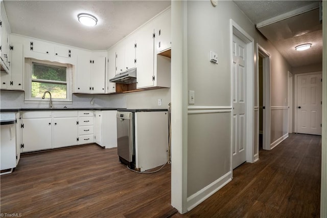 4362 Parsonsville Rd, Purlear, NC 28665 - kitchen with under cabinet range hood, dark countertops, dark wood-style flooring, a sink, and white cabinetry