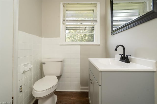 4362 Parsonsville Rd, Purlear, NC 28665 - half bathroom featuring vanity, toilet, tile walls, wood finished floors, and wainscoting
