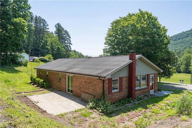 4362 Parsonsville Rd, Purlear, NC 28665 - view of side of home with brick siding, a patio, a chimney, and a lawn