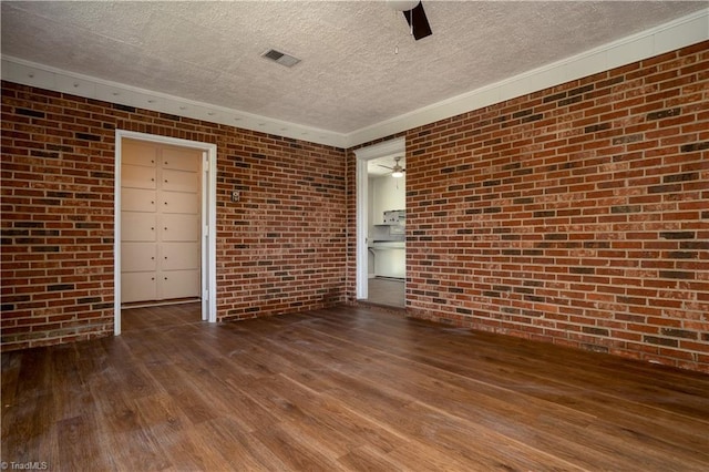 4362 Parsonsville Rd, Purlear, NC 28665 - spare room featuring brick wall, a textured ceiling, wood-type flooring, a ceiling fan, and ornamental molding