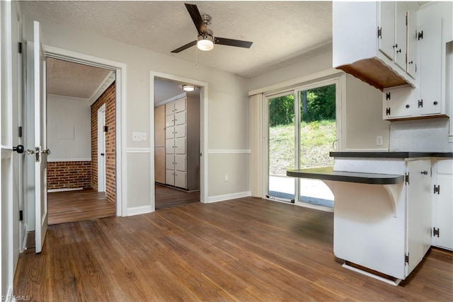 4362 Parsonsville Rd, Purlear, NC 28665 - kitchen with a textured ceiling, a ceiling fan, white cabinets, dark countertops, and dark wood finished floors