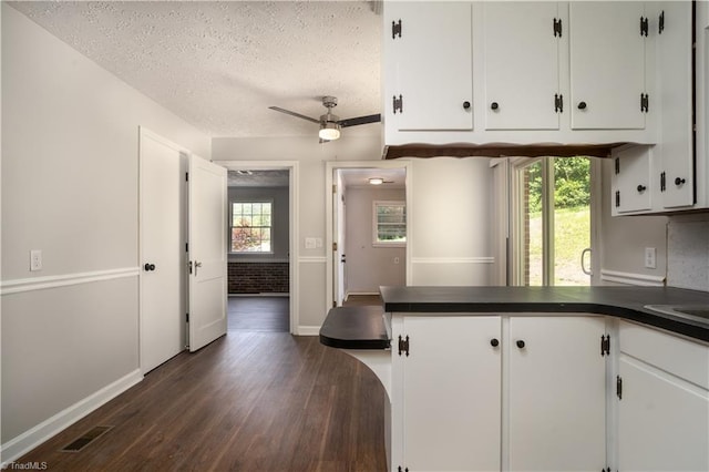 4362 Parsonsville Rd, Purlear, NC 28665 - kitchen with dark countertops, dark wood-style floors, white cabinetry, baseboards, and a peninsula