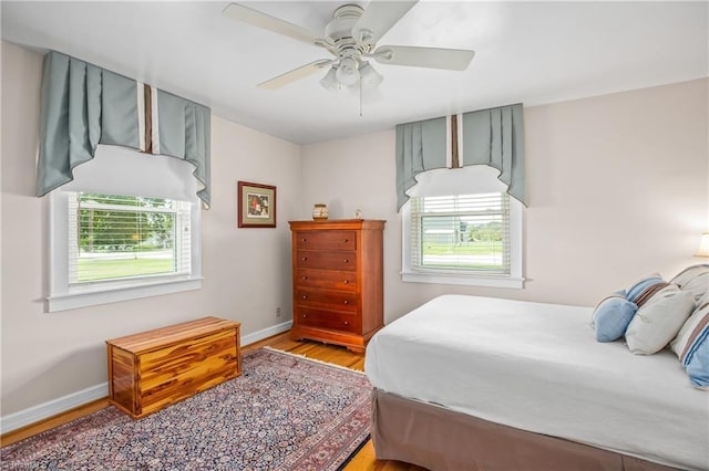 bedroom with light hardwood / wood-style floors and ceiling fan