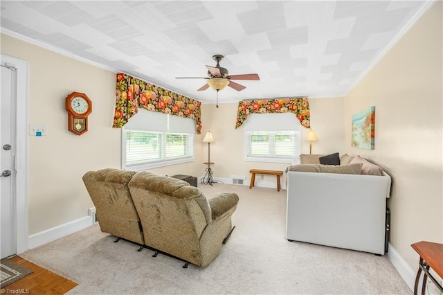 carpeted living room featuring ceiling fan and ornamental molding