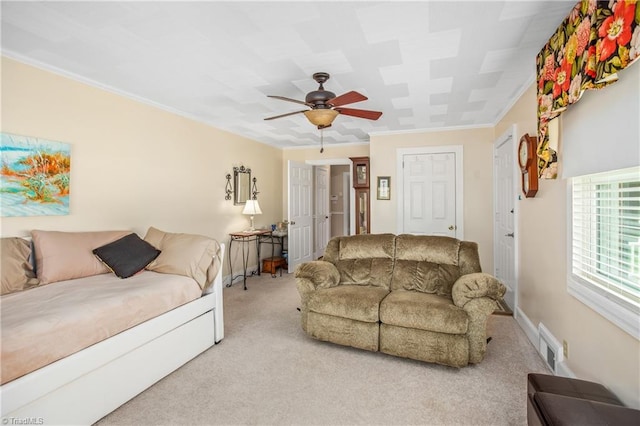 living room featuring light colored carpet, ceiling fan, and crown molding