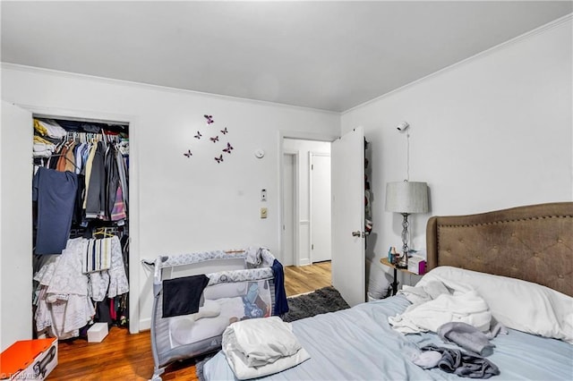 1515 Tucker St, Greensboro, NC 27405 - bedroom with wood finished floors, crown molding, and a closet