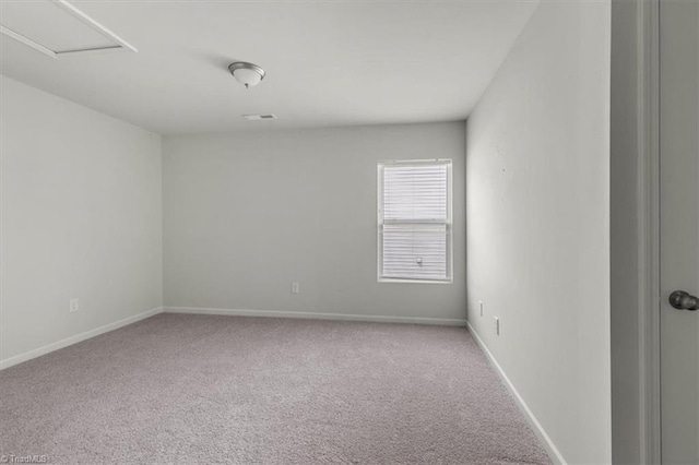 empty room featuring carpet and baseboards