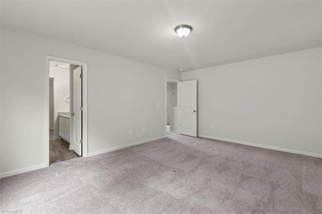 unfurnished bedroom featuring carpet and baseboards